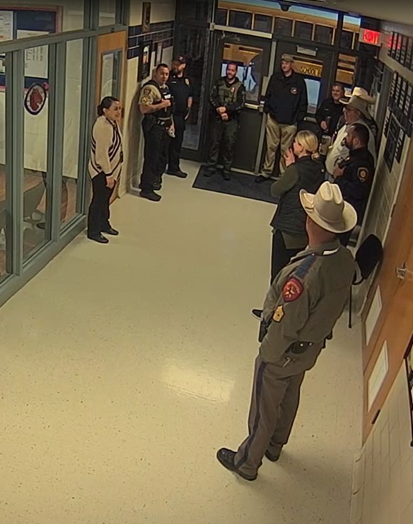  Local law enforcement standing in hall meeting with campus staff
